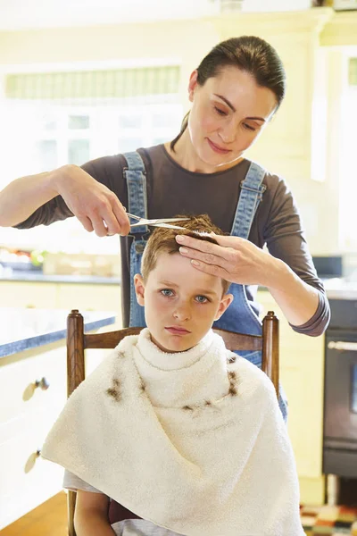 Portrait Unhappy Boy Getting Haircut Mother Kitchen — Stock Photo, Image