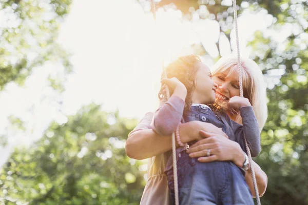 Grandmother Hugging Granddaughter Swing — Stock Photo, Image