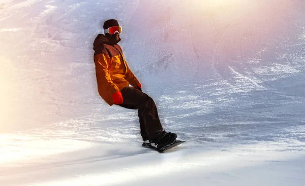 Snowboarder on snowboard  piste running downhill in beautiful Al