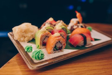Büyük bir Suşi Rolls-Ilık Ebi Sake Unagi Baharı. Lüks geleneksel restoranda, Japon çiğ balığından yapılan çeşitli Philadelphia dürümleri. Japon yemek menüsü servisi