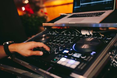 Dj 'in kırmızı parti dj ses donanımını kontrol ettiği genel çekim. Turntable top view gece kulübü ve not defterinde yüksek kaliteli karıştırma disk jokeyi. Gece kulübünde sahnede Pro ses ekipmanı.