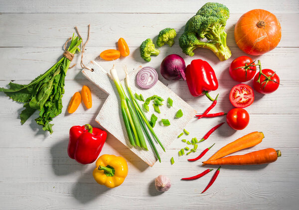 Healthy fresh vegetables on a white wooden background. Flat lay style