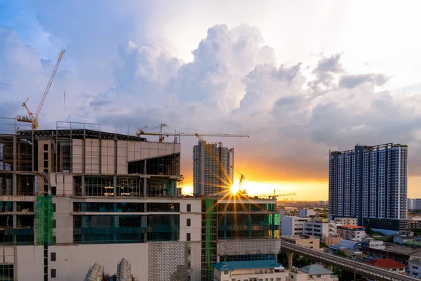 Construction site busy operate in beginning of building new complex infrastructure project at twilight time.