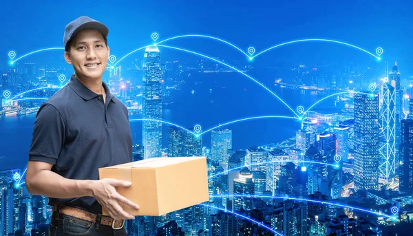 Asian delivery man holding a cardboard box with networking of internet of things — Stock Photo, Image