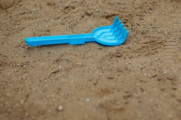 Childrens shovel lies in the sand. Hight quality photo