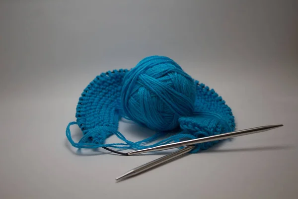 針仕事のための編み針と白い背景に青い糸のボール — ストック写真