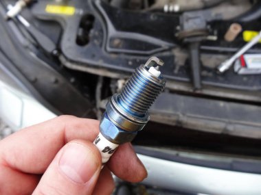 replacing spark plugs on a car clipart