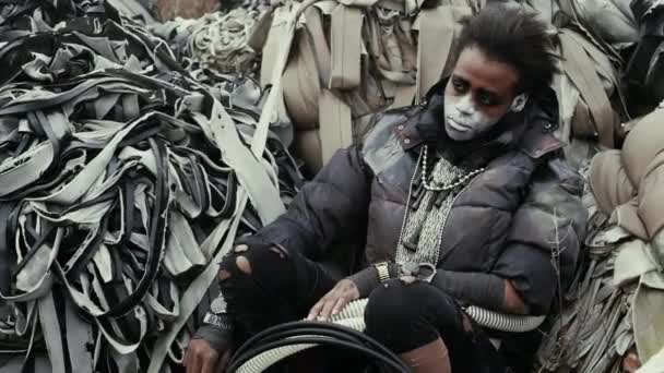Pós-apocalipse, jovem solitária senta-se no meio do depósito de lixo, ruínas — Vídeo de Stock