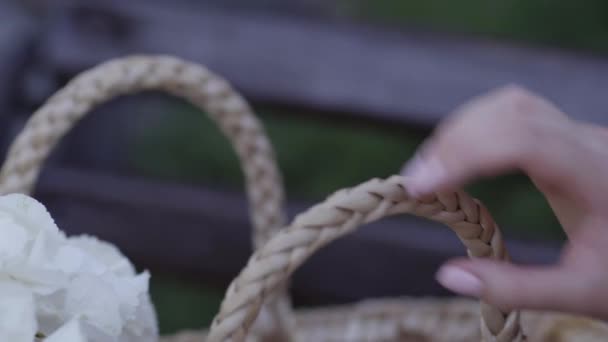 Une main d'une fille jette un sac de battement avec des fleurs, gros plan — Video