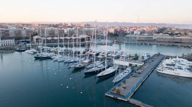 Aerial view of the pier with yachts and boats in the city of Valencia, Spain. Drone photography. clipart