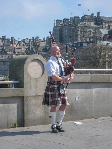 エジンバラ スコットランド 2014 エジンバラの背景に新古典主義の建物スコットランドの伝統的な衣装を着て 橋の上スコットランド演奏バグパイプのビュー — ストック写真