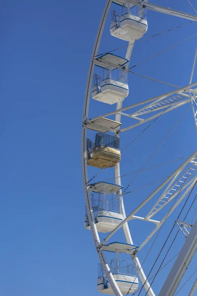 Giant ferris wheel with chairs, metallic structure, recreational element near the river, downtown of Gaia, Portugal