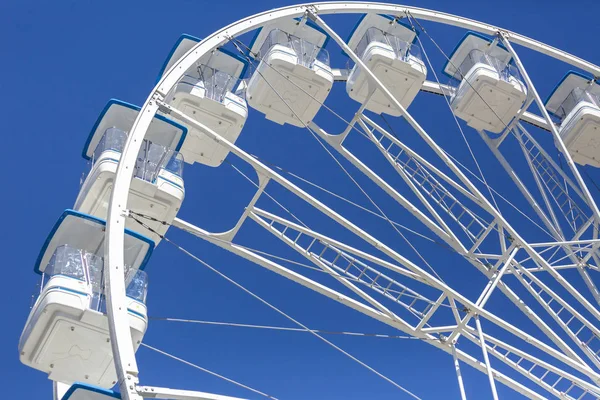 Giant ferris wheel with chairs, metallic structure, recreational element near the river, downtown of Gaia, Portugal
