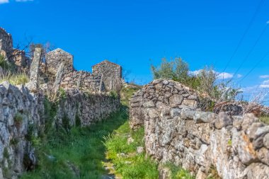 Geleneksel bir şekilde inşa edilmiş granitik taşbinalar ve duvarlar ile tarım alanları ile yaya yolu görünümü