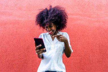 Elinde telefon olan mutlu Afrikalı Amerikalı.