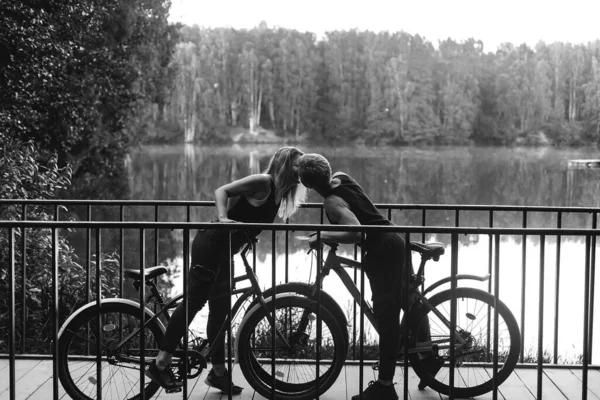 the Couple in love in the park on bicycles, black white photo