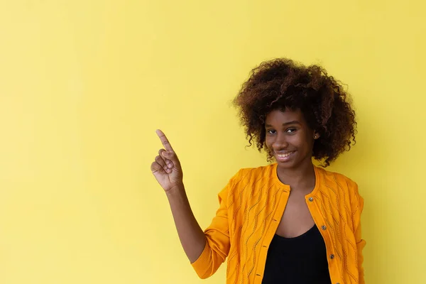 the beautiful and happy African American on a yellow background
