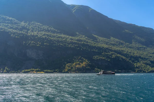 Norwegian fjord panorama, fjord cruise vessel under way. Aurlandsfjord fjord landscape from the water