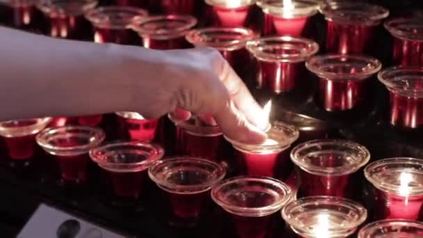 Young Women Hand Puts Burning Candle Red Glass Candle Holder — 비디오