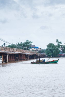 İki Khmer balıkçısı eski bir balıkçı teknesinde.