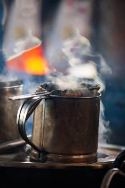 Kumaş filtre kahve ve eski paslanmaz çelik kaplar Luang Prabang, Laos 'taki eski kahve dükkanında buharlı. Yemek kültürü. Seçici odak.