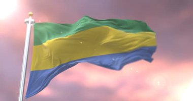 Yavaş, döngü içinde gün batımında, Gabon sallayarak bayrak Rüzgar