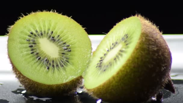 Kiwi Fruit Sliced Half Gyrating Black Background — Stock Video