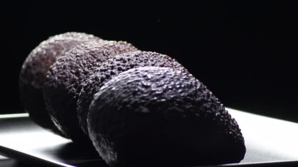 Hass Avocados Fruit Gyrating Black Background — Stock Video