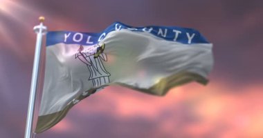 Flag of Yolo county in California at sunset, region of the United States - loop