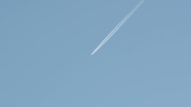 青い空を横切るジェット反応器飛行機は長い白い目覚めを残し — ストック動画