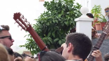 Verdiales Panda singing among the crowd at the festivities of an Andalusian town