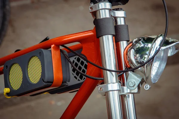 headlight and music concept with small loudspeaker on on the frame of the bike.