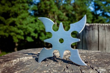 Shuriken (fırlatma yıldızı), geleneksel Japon Ninja soğuk silahı ahşap arka planda sıkışmış