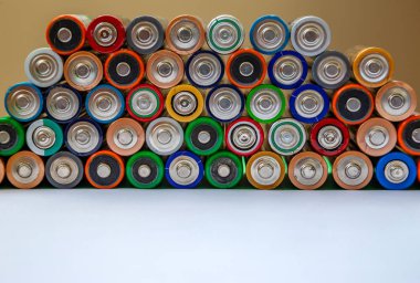 Closeup of saws of used alkaline batteries. Several in rows. Eco clipart
