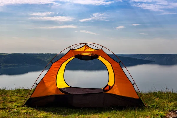 Tourist tent by the river overlooking the canyon. Outdoor recreation in summer. travel to Europe.