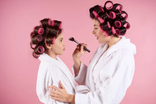 Adolescente chica con rulos haciendo maquillaje a mamá . —  Fotos de Stock