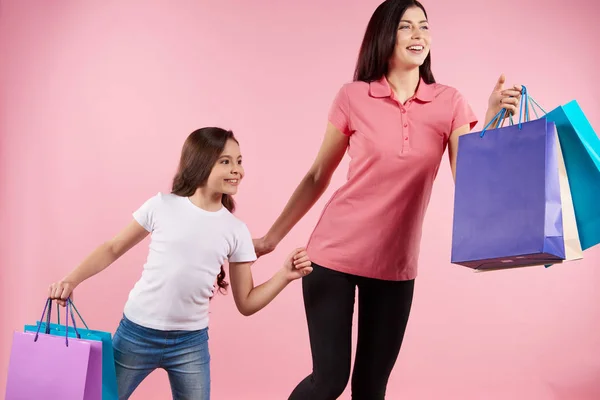 Pretty mom and daughter in casual clothes