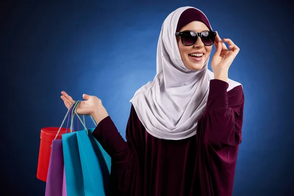 Arabische vrouw in zonnebril houdt papieren zakken gekleurd — Stockfoto
