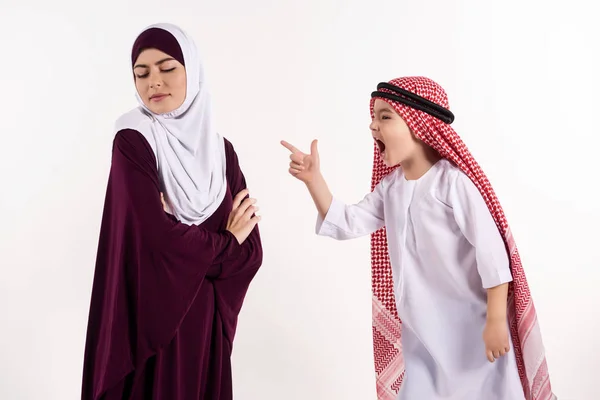 Arab boy is arguing with mother in hijab. — Stock Photo, Image
