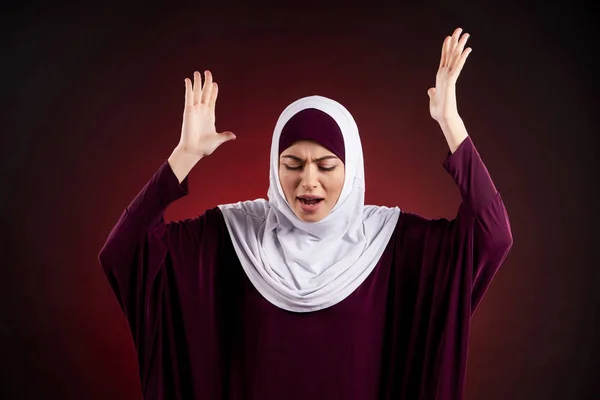 Arab woman in hijab expresses anger and discontent