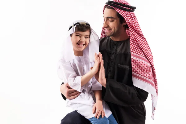 Arabian boy gives five fathers in keffiyeh. — Stock Photo, Image