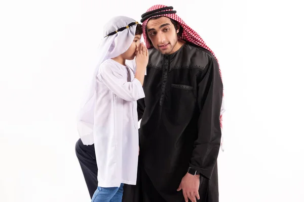 Arabian boy tells secret to father ear in keffiyeh — Stock Photo, Image