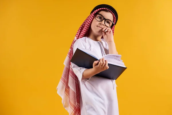 Arab happy boy with glasses makes notes — Stock Photo, Image