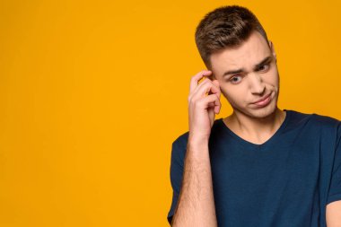 Genç yakışıklı adam şaşkınlık içinde duruyor