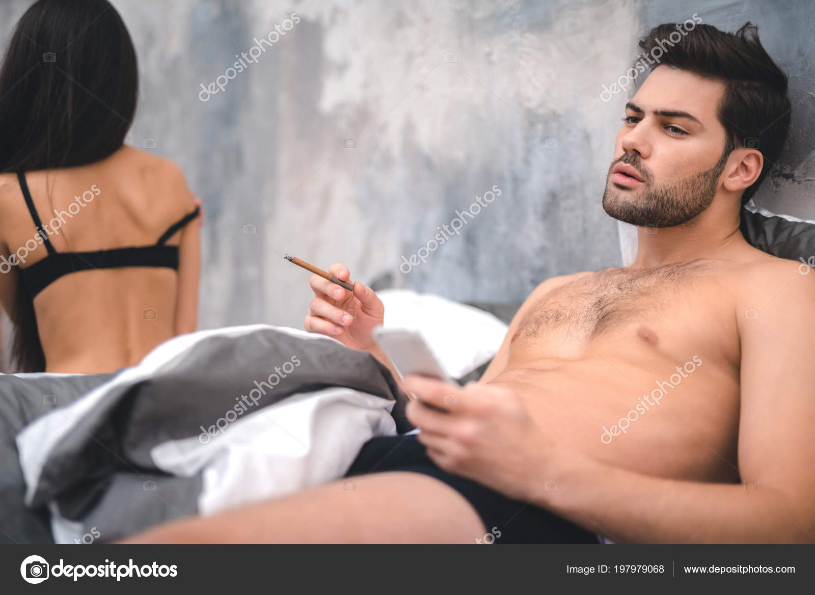 Presentable man smoking after sex in bedroom Stock Photo by ©stockveres.gmail 197979068