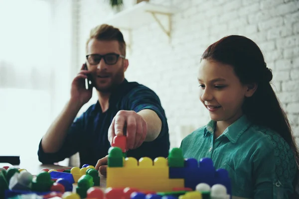 Busy single father works and looks like daughter — Stock Photo, Image