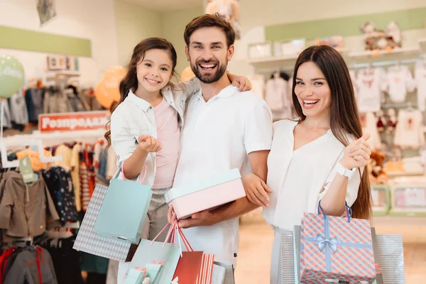 Família, pai, mãe e filha estão na loja de roupas do shopping . — Fotografia de Stock