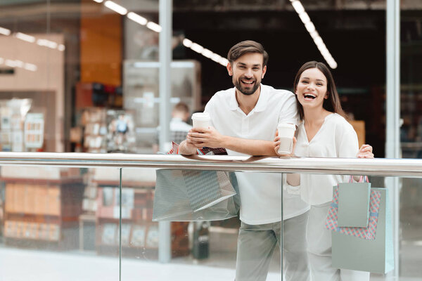 Man and woman in shopping mall. Couple is relaxing, happy after shopping.