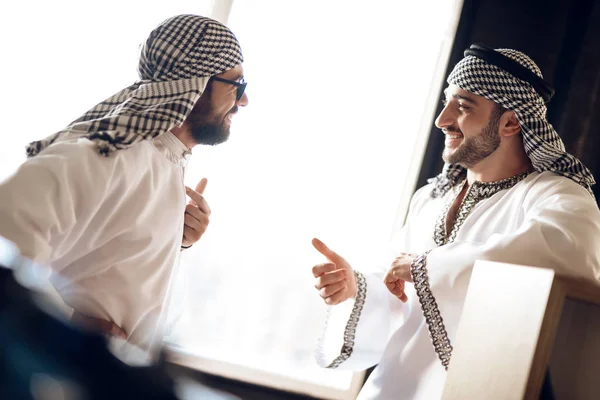 Two arab businessmen speaking behind the window at hotel room. — Stock Photo, Image
