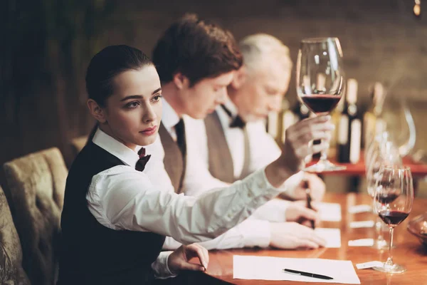 Group of sommeliers make wine card in restaurant. Tasting of elite alcoholic beverages. — Stock Photo, Image
